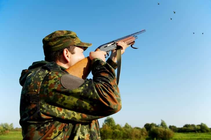 photo-hunter-shooting-with-rifle-gun